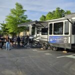 Summit 7.3's 2024 tailgate welcomes guests by the camper to enjoy a time of networking.